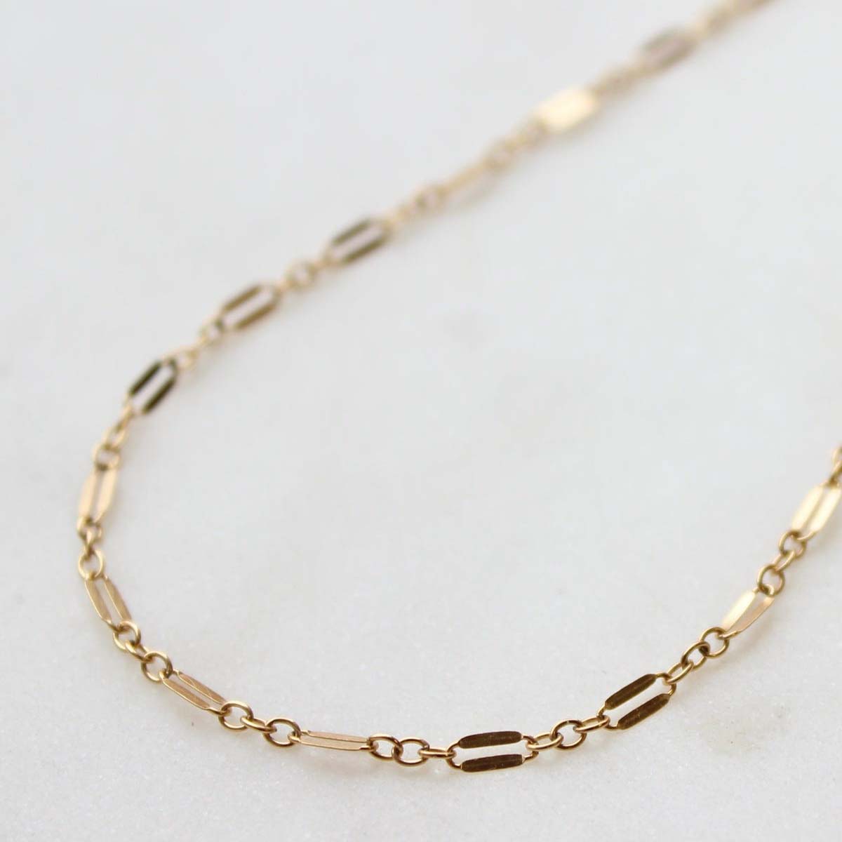 A close up of lace choker on a table.