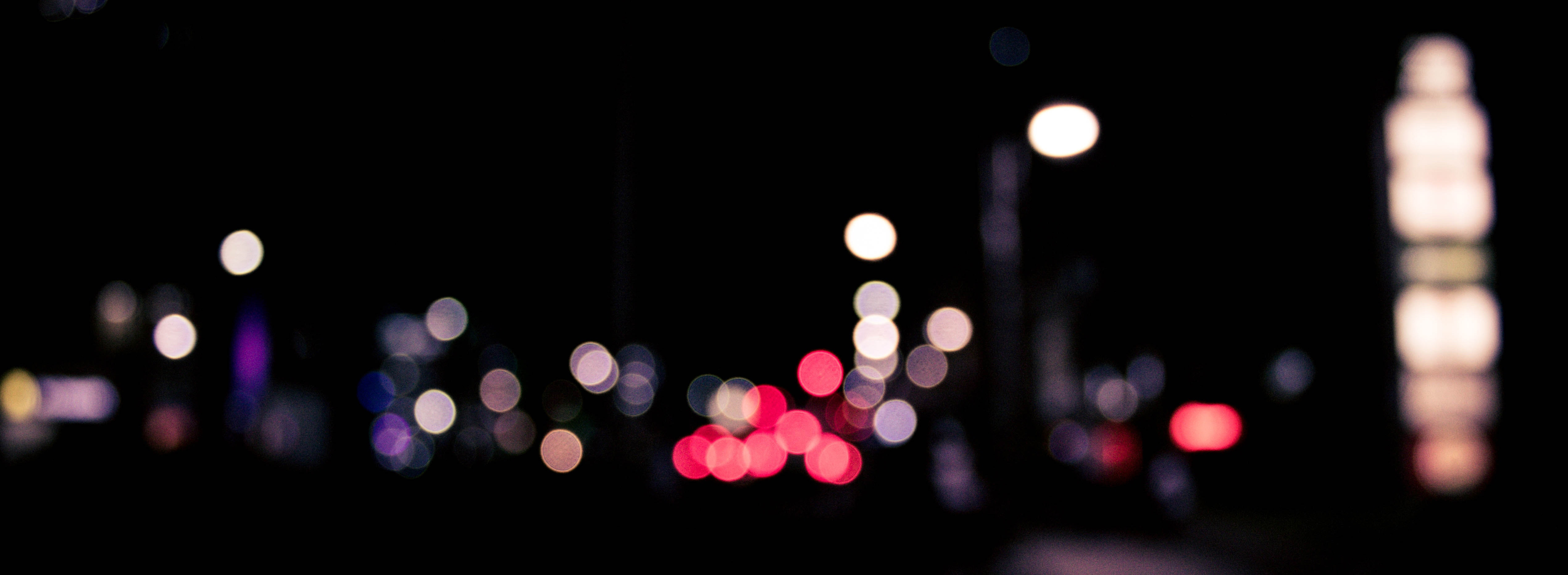 A blurry image of city lights in the distance.