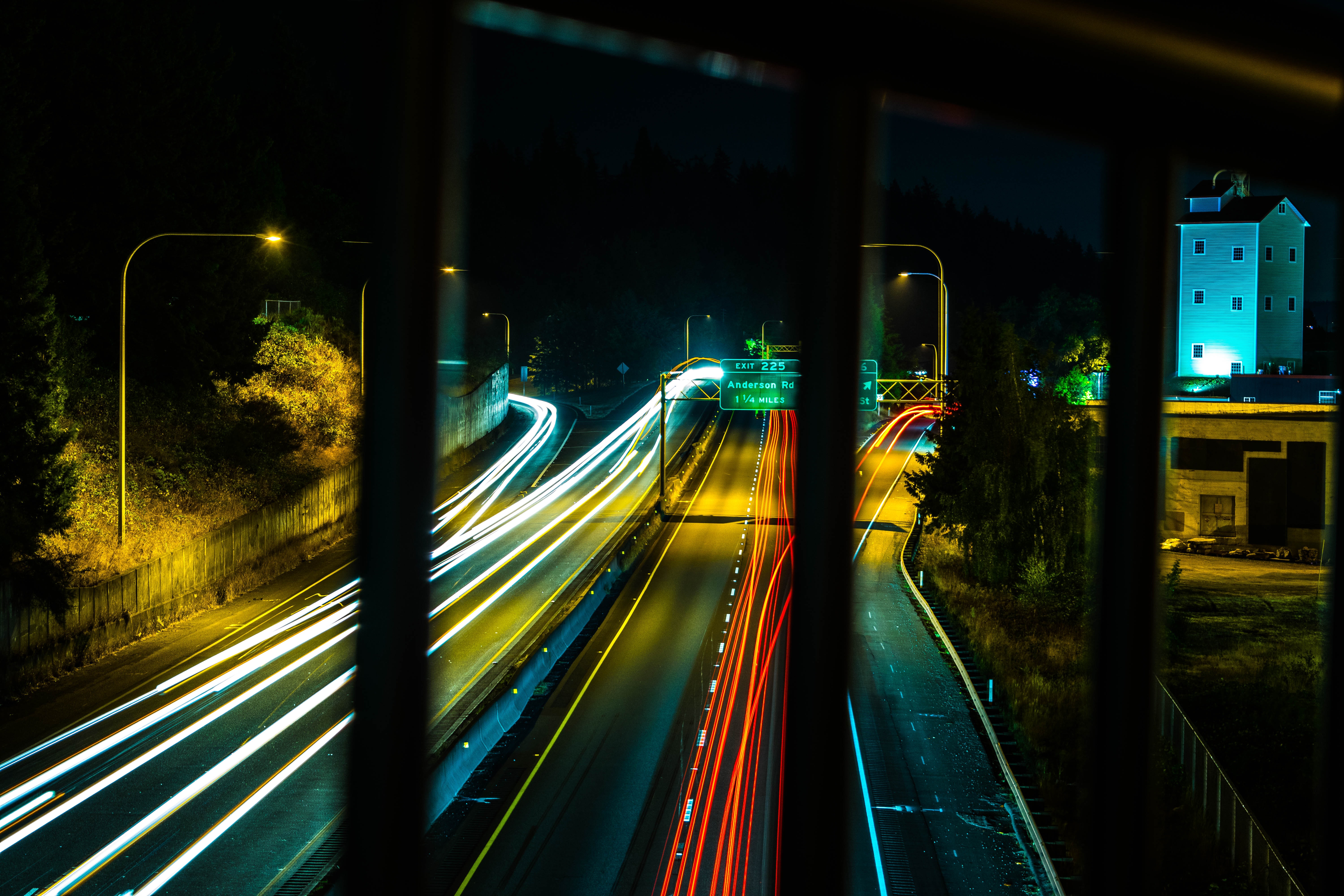 A long exposure shot looking down at a freeway at night.