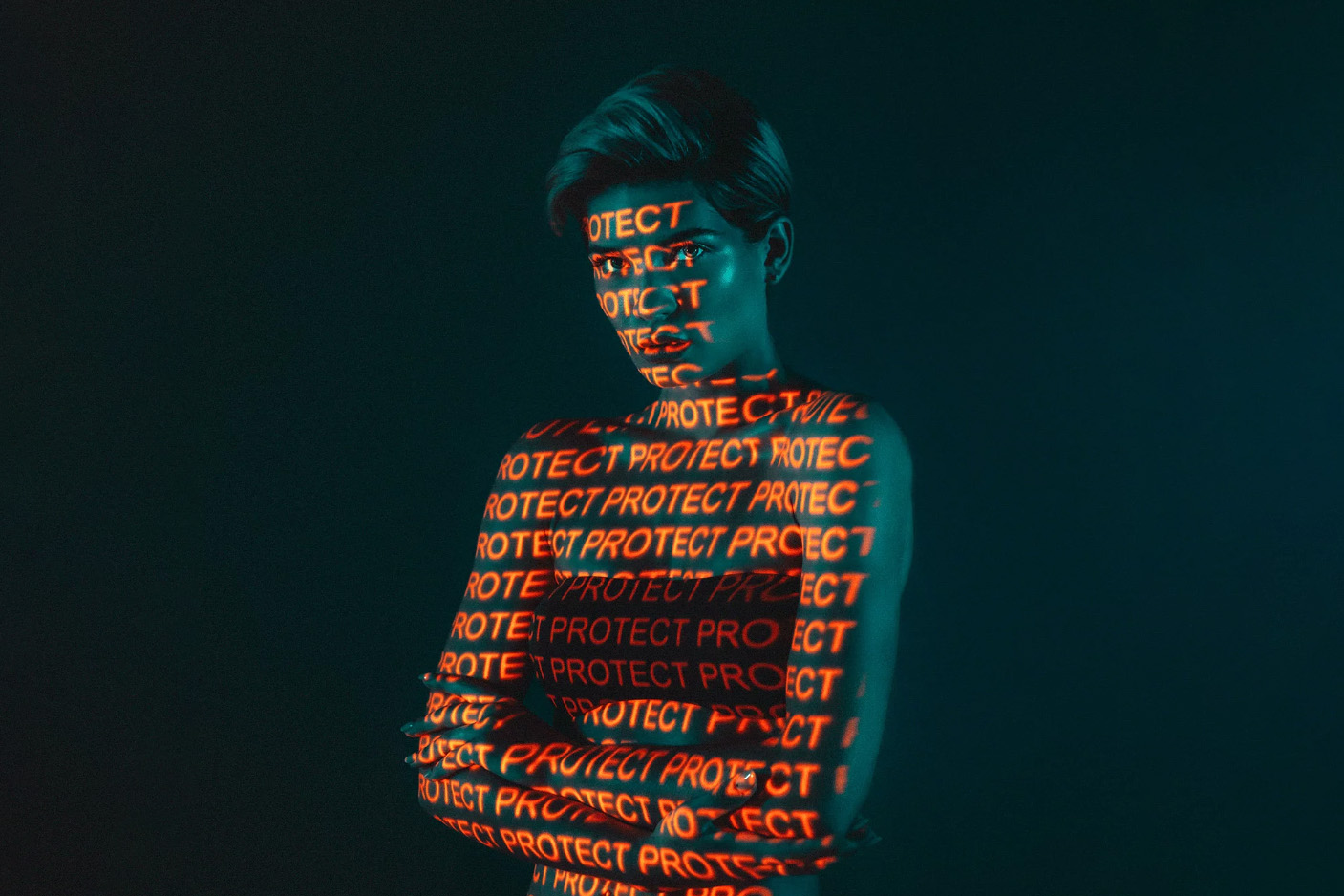 A medium crop photo of a women with an orange projection.